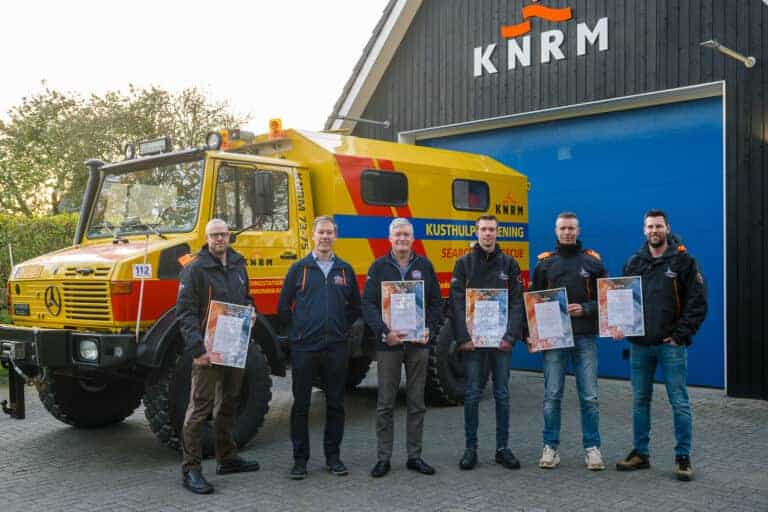 De oorkonde voor bemanning KNRM Ameland met KNRM-directeur Jacob Tas.